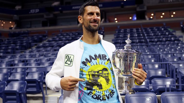 Novak Djokovic of Serbia poses for the media with his winners trophy wearing a shirt as a tribute to the late Kobe Bryant after defeating Daniil Medvedev of Russia during their Men's Singles Final match on Day Fourteen of the 2023 US Open at the USTA Billie Jean King National Tennis Center on September 10, 2023 in the Flushing neighborhood of the Queens borough of New York City. (Photo by Clive Brunskill/Getty Images)