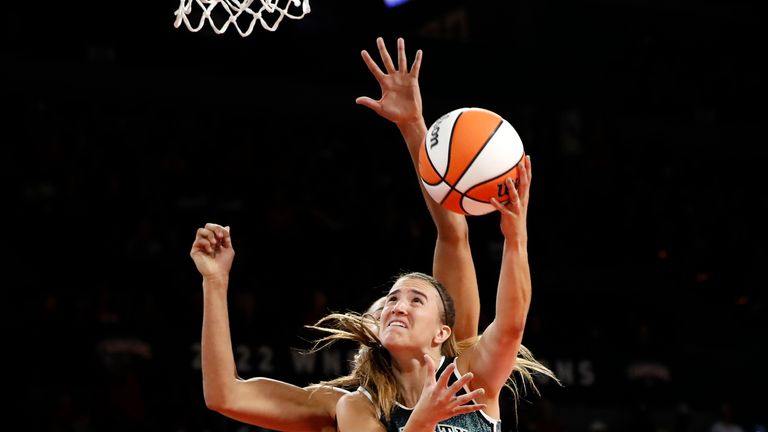 New York Liberty guard Sabrina Ionescu shoots next to Las Vegas Aces guard Jackie Young 